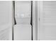 A stackable white washer and dryer set is conveniently located near the louvered door at 6203 Catalina Dr. # 1832, North Myrtle Beach, SC 29582