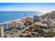 An aerial view features buildings, and the ocean under a clear sky at 6900 N Ocean Blvd. # 208, Myrtle Beach, SC 29572