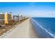 Expansive aerial view of a beach and oceanfront condos on a clear day at 6900 N Ocean Blvd. # 208, Myrtle Beach, SC 29572