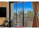 Balcony view of palm trees and the ocean, with furniture and a partial view of the bed at 6900 N Ocean Blvd. # 208, Myrtle Beach, SC 29572