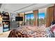 Bright bedroom with a balcony view of palm trees and the ocean at 6900 N Ocean Blvd. # 208, Myrtle Beach, SC 29572