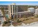 Beautiful exterior view of a multistory building with a pool and beach access at 6900 N Ocean Blvd. # 208, Myrtle Beach, SC 29572