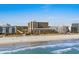 A daytime exterior shot of an oceanfront property along the beach at 6900 N Ocean Blvd. # 208, Myrtle Beach, SC 29572