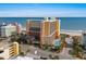 A daytime exterior view shows the buildings, the beach, and a pool at 6900 N Ocean Blvd. # 208, Myrtle Beach, SC 29572