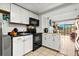 Open kitchenette with updated appliances and bright view into the studio apartment at 6900 N Ocean Blvd. # 208, Myrtle Beach, SC 29572