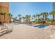 Relaxing hot tub area surrounded by palm trees and brick pavers at 6900 N Ocean Blvd. # 208, Myrtle Beach, SC 29572