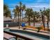 Balcony view of a lazy river pool and palm trees leading to the beach at 6900 N Ocean Blvd. # 208, Myrtle Beach, SC 29572