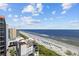Beautiful beach view with a nice blue ocean and many tourists enjoying the sunny day with fluffy clouds at 7100 Ocean Blvd. N # 1425, Myrtle Beach, SC 29572