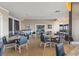 Bright dining area with wood floors, comfortable blue chairs, and views of the ocean in the distance at 7100 Ocean Blvd. N # 1425, Myrtle Beach, SC 29572