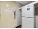 Entry area of the unit with a door and a refrigerator unit at 7100 Ocean Blvd. N # 1425, Myrtle Beach, SC 29572