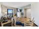 Relaxing living room with a gray sofa, balcony access, and dining area at 7100 Ocean Blvd. N # 1425, Myrtle Beach, SC 29572
