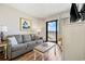 Cozy living room with a gray sofa and a view of the ocean from the balcony at 7100 Ocean Blvd. N # 1425, Myrtle Beach, SC 29572
