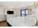 Inviting main bedroom with a plush king bed, balcony access, and ample dresser storage space at 7100 Ocean Blvd. N # 1425, Myrtle Beach, SC 29572