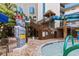 Outdoor water park with a tall staircase leading to water slides, a tiki hut, and decorative totem statues at 7100 Ocean Blvd. N # 1425, Myrtle Beach, SC 29572