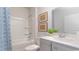 Cozy bathroom featuring a tub, neutral tile, and a framed mirror above the vanity at 719 Chazen Way, Longs, SC 29568