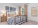 Warm bedroom with an industrial bed frame, natural light, and wood furnishings at 719 Chazen Way, Longs, SC 29568