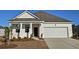 Charming single-story home with a well-maintained front yard and an attached two-car garage at 719 Chazen Way, Longs, SC 29568