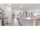 Open-concept kitchen with granite countertops, stainless steel appliances, and an open dining area at 719 Chazen Way, Longs, SC 29568