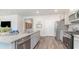 Open kitchen boasts granite countertops, a stainless steel dishwasher, and modern appliances at 719 Chazen Way, Longs, SC 29568