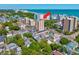 An aerial view of a tall condo building by the beach with surrounding neighborhood and ocean views at 7509 N Ocean Blvd. # 101, Myrtle Beach, SC 29572