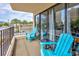 Balcony view with furniture and railings overlooking buildings and palm trees at 7509 N Ocean Blvd. # 101, Myrtle Beach, SC 29572