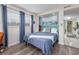 Cozy bedroom features wood-look floors, a comfortable bed, and a view of the kitchen at 7509 N Ocean Blvd. # 101, Myrtle Beach, SC 29572