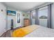 Bright bedroom with a view of the windows, stylish bed, and modern decor at 7509 N Ocean Blvd. # 101, Myrtle Beach, SC 29572