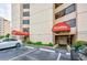 Exterior of a building with parking spaces, landscaping, and signage at 7509 N Ocean Blvd. # 101, Myrtle Beach, SC 29572