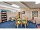 Cozy game room with comfortable seating, a glass-topped table, and a bookshelf at 7509 N Ocean Blvd. # 101, Myrtle Beach, SC 29572