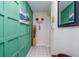 Hallway featuring decorative wall paneling and artistic wall decor with a view to the front entrance at 7509 N Ocean Blvd. # 101, Myrtle Beach, SC 29572