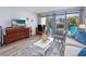 Open-concept living room with balcony access offering a cozy area for relaxation and enjoying the view at 7509 N Ocean Blvd. # 101, Myrtle Beach, SC 29572