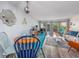 Bright living room featuring a dining area, stylish furniture, and a sliding glass door to a balcony at 7509 N Ocean Blvd. # 101, Myrtle Beach, SC 29572