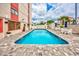 Outdoor swimming pool with lounge chairs and patio with access to the building at 7509 N Ocean Blvd. # 101, Myrtle Beach, SC 29572