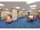 Large recreation room with seating and tables for hosting social events and entertaining at 7509 N Ocean Blvd. # 101, Myrtle Beach, SC 29572