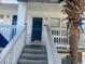 Entrance view showcasing stairs leading up to door and partial view of palm tree at 804 12Th Ave. S # 218, North Myrtle Beach, SC 29582