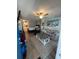 Living room view of fully furnished studio unit with hardwood floors, bright ceiling fan, and beach themed decor at 804 12Th Ave. S # 218, North Myrtle Beach, SC 29582