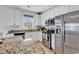Modern kitchen with stainless steel appliances, granite countertops, and white cabinetry at 820 Madiera Dr. # 14, North Myrtle Beach, SC 29582