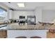 Well-lit kitchen with granite countertops, stainless steel appliances, and white cabinetry at 820 Madiera Dr. # 14, North Myrtle Beach, SC 29582