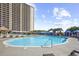 Expansive pool area with palm trees, seating, and beautiful high-rise views at 820 Madiera Dr. # 14, North Myrtle Beach, SC 29582