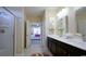 Bathroom with dual sinks, dark wood cabinets, and a separate shower room at 860 Ireland Dr., Longs, SC 29568