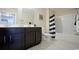 Modern bathroom featuring dark wood cabinetry, tile flooring, and a shower-tub combo at 860 Ireland Dr., Longs, SC 29568