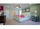 Bright bedroom featuring a plush bed with decorative pillows and ceiling fan at 860 Ireland Dr., Longs, SC 29568