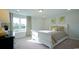 Bright bedroom featuring a white bed, neutral bedding, and large window at 860 Ireland Dr., Longs, SC 29568