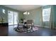 Bright dining area boasts stylish decor, natural light, and access to a screened-in porch at 860 Ireland Dr., Longs, SC 29568