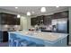 Modern kitchen island with seating, stainless steel appliances, and dark wood cabinets at 860 Ireland Dr., Longs, SC 29568