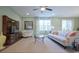Cozy living room features a ceiling fan, neutral furniture, and large windows for plenty of natural light at 860 Ireland Dr., Longs, SC 29568
