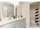 Bathroom with double vanity, granite counters, mirrors, and an adjacent shower/tub enclosure at 867 Ireland Dr., Longs, SC 29568