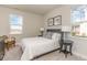 Well-lit bedroom with modern decor, comfortable bed, and inviting natural light from two windows at 867 Ireland Dr., Longs, SC 29568