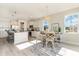 Cozy dining area with a modern chandelier, white trim windows, and views of the kitchen at 867 Ireland Dr., Longs, SC 29568