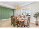 Dining room featuring modern light fixture, wooden table and decorative wall paneling at 867 Ireland Dr., Longs, SC 29568